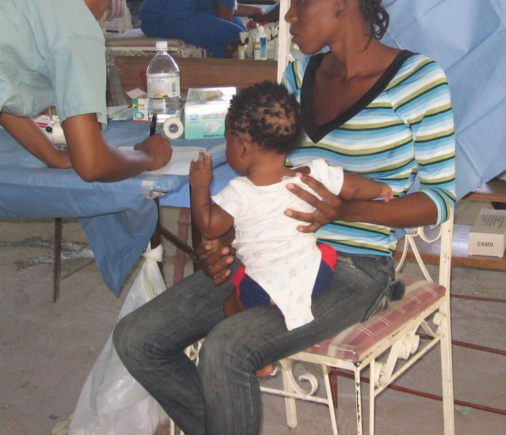 Madre con su hijo en una clínica tras el terremoto de Haití
